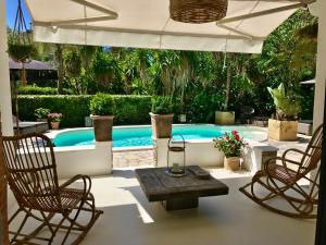 a swimming pool with two chairs and a table at Villa Riviera in Cannes