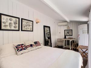 a bedroom with a white bed with two pillows on it at Villa Riviera in Cannes +12 photos