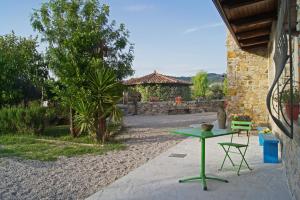 a green table and a chair on a patio at Agriturismo Mammarella in Altavilla Silentina