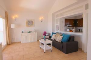 a living room with a couch and a table at Villa Princesa Sofia in Puerto del Carmen