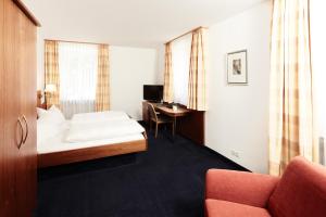 Postel nebo postele na pokoji v ubytování Hotel Burgmeier