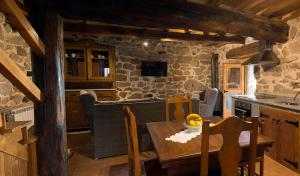 a kitchen and dining room with a wooden table at Casa Dos Fuelles in Ourense