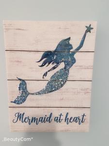 a mermaid at heart wood sign with a mermaid at heart mermaid art at EN SUITE NEXT TO FELLS POINT in Baltimore