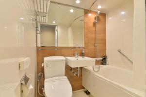 
a bathroom with a toilet, sink, and bathtub at Hakodate Kokusai Hotel in Hakodate

