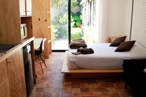 a bedroom with a bed and a kitchen with a window at Coyoacan City Lofts in Mexico City +75 photos