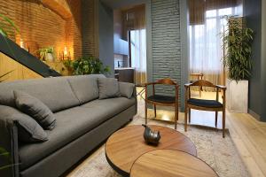 a living room with a couch and a table and chairs at Paskunji Residence in Tbilisi City