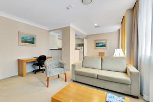 a living room filled with furniture and a couch at Manor Apartment Hotel in Brisbane