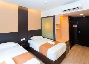 Postel nebo postele na pokoji v ubytování Icon Hotel Segamat
