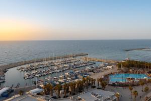 a marina with a bunch of boats in the water at Herods Tel Aviv By The Beach in Tel Aviv