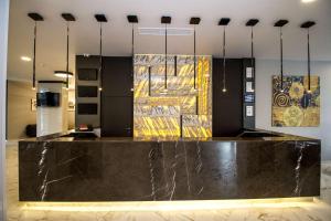 a lobby with a marble counter and paintings on the wall at Best Western PLUS Premium Inn in Sunny Beach