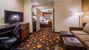 a hotel room with a couch and a television at Best Western Plus Suites Hotel Coronado Island in San Diego