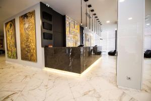 a lobby with a marble counter and paintings on the walls at Best Western PLUS Premium Inn in Sunny Beach