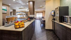 a lobby of a hotel with a counter with fruit on it at Best Western Plus Sanford Airport/Lake Mary Hotel in Sanford