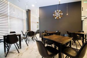 a dining room with tables and chairs and a chandelier at Best Western PLUS Premium Inn in Sunny Beach