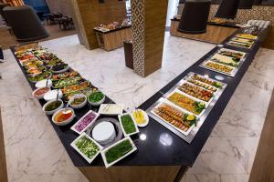 a buffet of different types of food on a table at Best Western PLUS Premium Inn in Sunny Beach