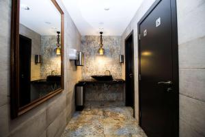 a bathroom with two sinks and a black door at Best Western PLUS Premium Inn in Sunny Beach