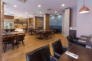 a restaurant with tables and chairs in a restaurant at Best Western PLUS Premium Inn in Sunny Beach