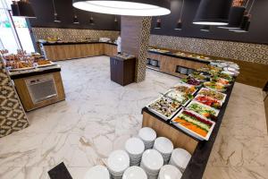 a buffet line with a lot of food on display at Best Western PLUS Premium Inn in Sunny Beach