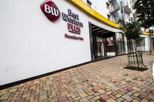 a building with a sign on the side of it at Best Western PLUS Premium Inn in Sunny Beach