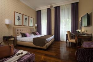 
a bedroom with a large bed and a large window at Hotel Imperiale by OMNIA hotels in Rome
