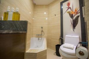 a bathroom with a toilet and a sink at Boracay Haven Suites in Boracay