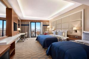 A bed or beds in a room at Ramada by Wyndham Sakarya Hendek