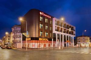 a building in a parking lot at night at Ramada by Wyndham Sakarya Hendek in Hendek