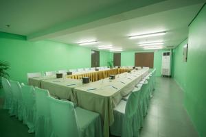 a large conference room with tables and white chairs at Boracay Haven Suites in Boracay