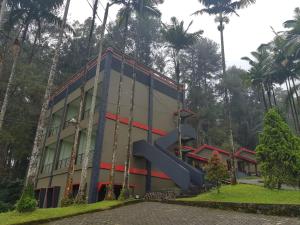 a building with a slide in front of it at Surya Hotel & Resort in Baturaden