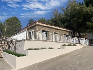 a house with a balcony on the side of it at Iliovasilema in Platy