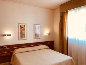 Postel nebo postele na pokoji v ubytování Hotel Delfina