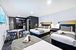 Voodi või voodid majutusasutuse CBD Motor Inn toas
