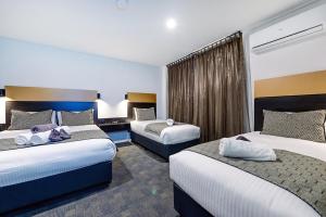 Voodi või voodid majutusasutuse CBD Motor Inn toas