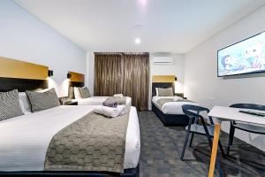 Voodi või voodid majutusasutuse CBD Motor Inn toas