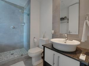 Un baño con lavabo, inodoro y ducha. en Point Bay - Super Stylish for Less, en Durban 26 fotos más