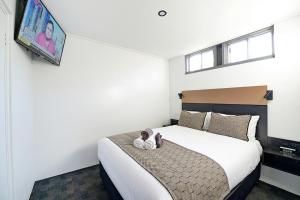 Voodi või voodid majutusasutuse CBD Motor Inn toas