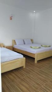 two beds sitting next to each other in a room at Mai DaLat Homestay in Da Lat +20 photos