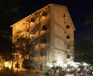a large brick building at night at Hotel Club Ramon in Mitzpe Ramon
