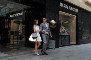 a man and a woman standing in front of a store at Mandarin Oriental Hong Kong in Hong Kong