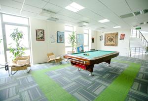 a billiard room with a pool table in it at HomeBridge Hotel Apartments in Baku