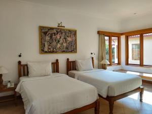 Postel nebo postele na pokoji v ubytování Puri Mesari Hotel + 23 fotografií