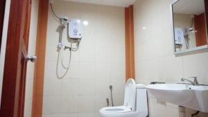 a bathroom with a shower and a toilet and a sink at Baron Water Front in Kuah