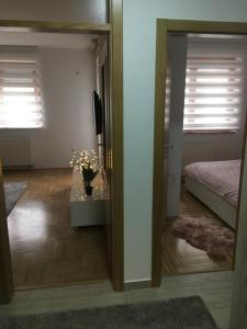 a room with a bedroom with a bed and a mirror at Annabel’s Home in Sarajevo