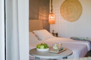 a table with a bowl of fruit on a bed at Nissi Beach Resort in Ayia Napa
