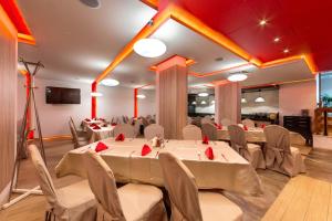 a banquet hall with tables and chairs in a room at Belvedere Holiday Club in Bansko