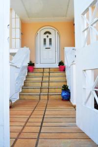 a hallway with stairs leading to a white door at Villa View-Topia in Theológos