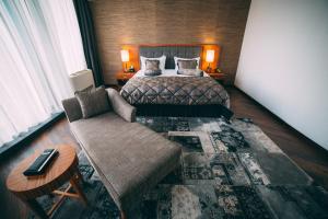 a hotel room with a bed and a couch at Damas International Hotel in Bishkek