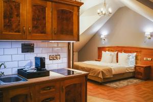 a kitchen with a bed and a sink in a room at Hotel & Apartments Ventus Rosa in Bielsko-Biała