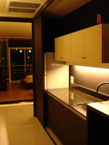 a kitchen with a view of a living room at room 5 pattaya tower in Pattaya Central