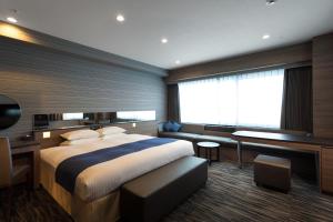 Postel nebo postele na pokoji v ubytování Hotel Hewitt Koshien